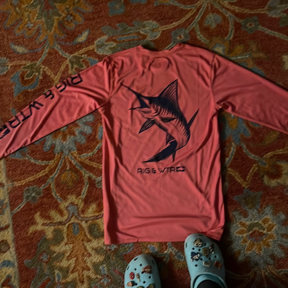 Worn once. Pink with dark blue writing and picture on the back. No damage.